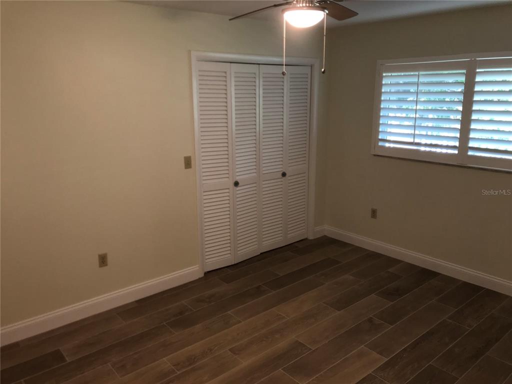 7806 17th Avenue Northwest Bradenton, FL 34209 - Photo 25 of 33 a view of an empty room with wooden floor and a window