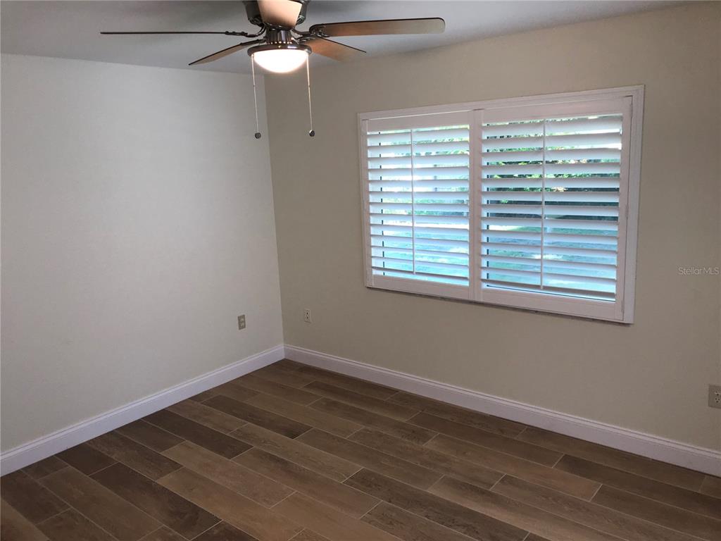 7806 17th Avenue Northwest Bradenton, FL 34209 - Photo 27 of 33 a view of an empty room with wooden floor and a window