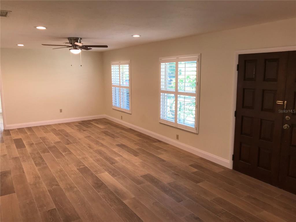 7806 17th Avenue Northwest Bradenton, FL 34209 - Photo 7 of 33 a view of an empty room with a window and wooden floor