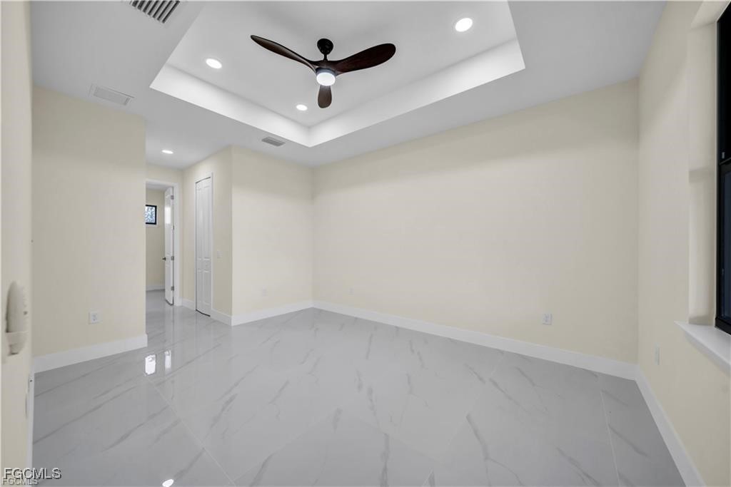 4306 2nd Street Southwest Lehigh Acres, FL 33976 - Photo 14 of 21 an empty room with ceiling fan and window