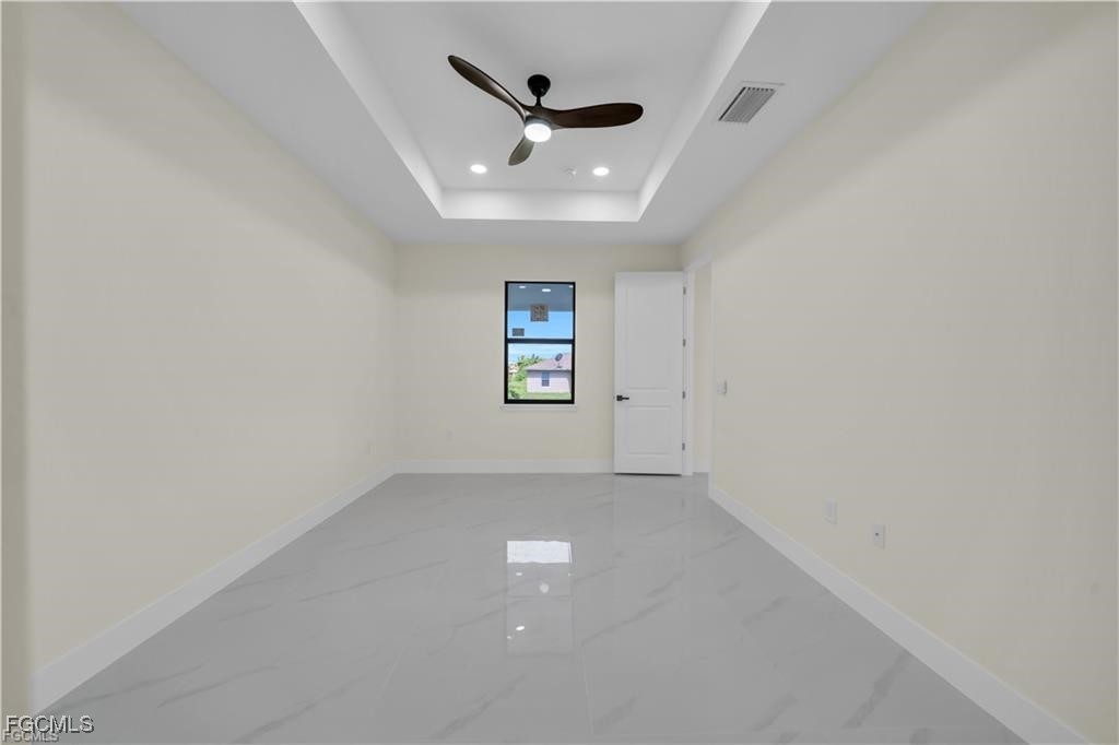 4306 2nd Street Southwest Lehigh Acres, FL 33976 - Photo 16 of 21 an empty room with ceiling fan and windows