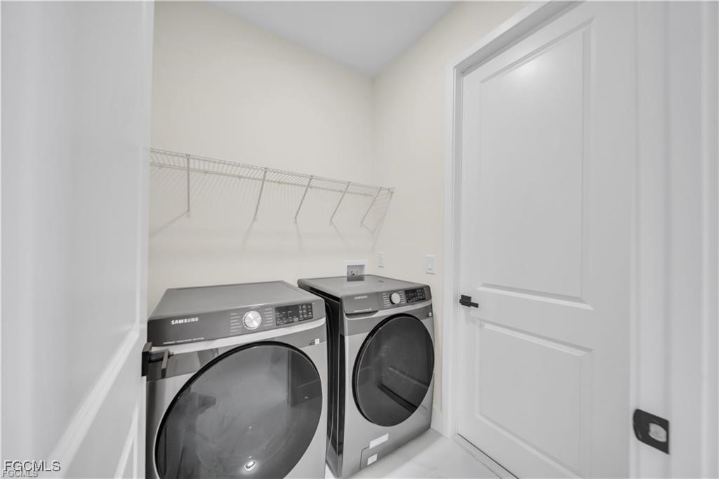 4306 2nd Street Southwest Lehigh Acres, FL 33976 - Photo 19 of 21 a utility room with dryer and washer