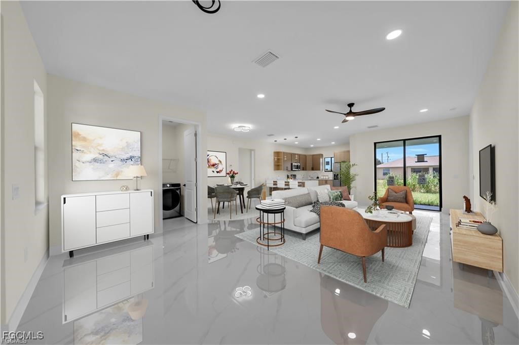 4306 2nd Street Southwest Lehigh Acres, FL 33976 - Photo 5 of 21 a living room with furniture and a flat screen tv