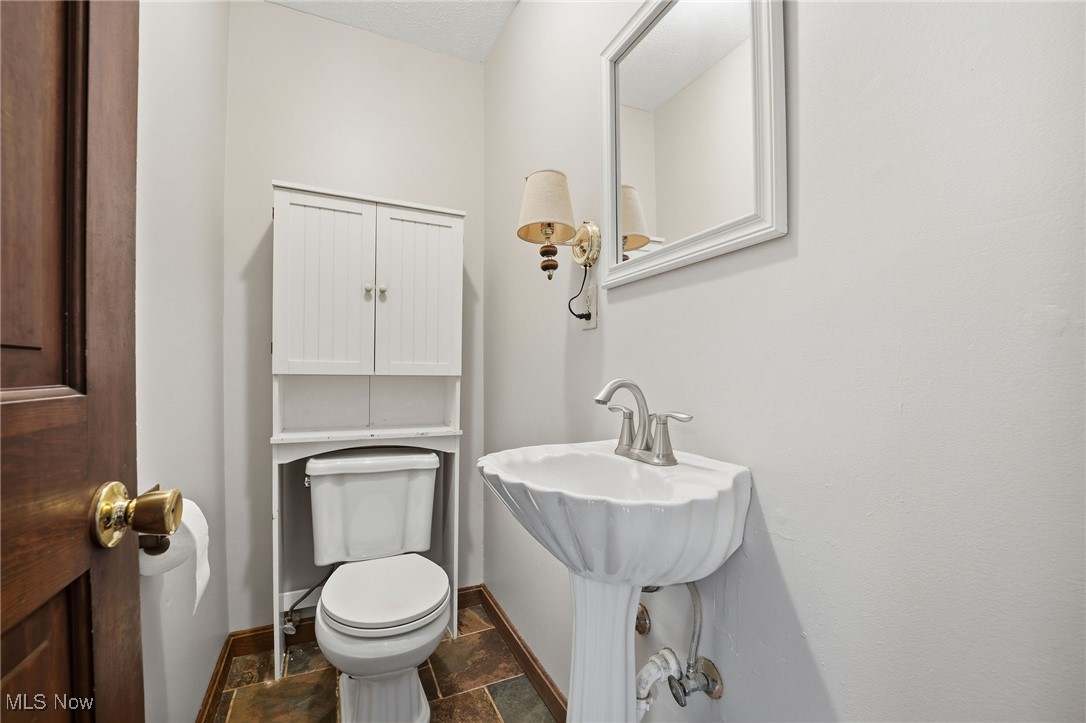 11710 Butternut Road Chardon, OH 44024 - Photo 20 of 48 Half bathroom with toilet and stone tile flooring