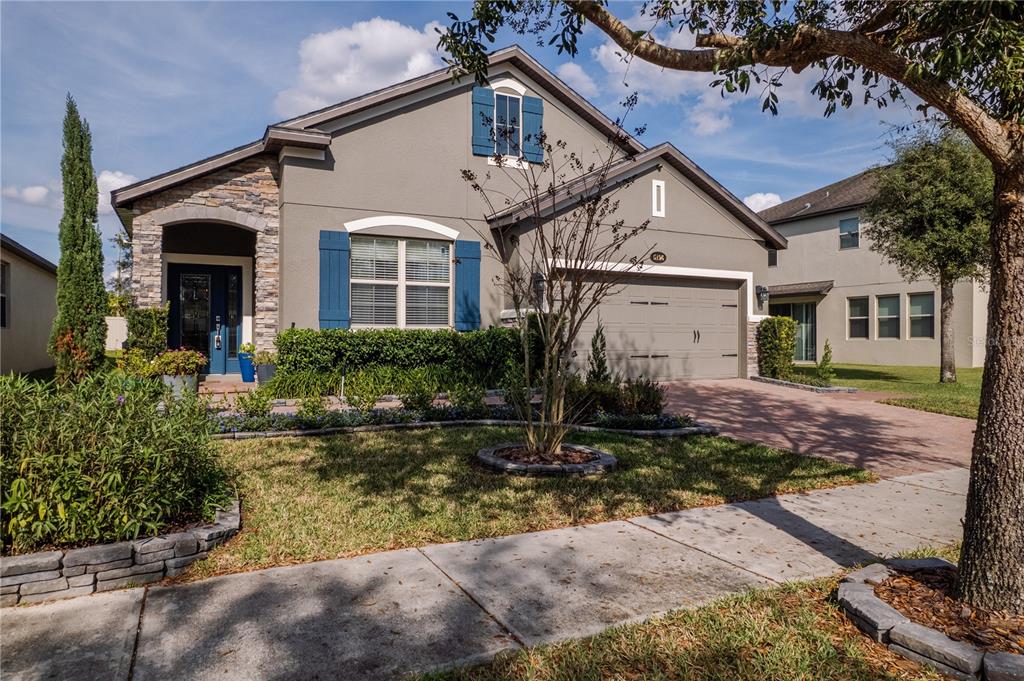 5196 Appenine Loop East St. Cloud, FL 34771 - Photo 1 of 39 a front view of a house with garden