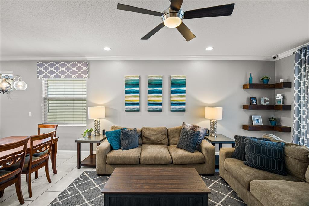 5196 Appenine Loop East St. Cloud, FL 34771 - Photo 12 of 39 a living room with furniture and a view of kitchen