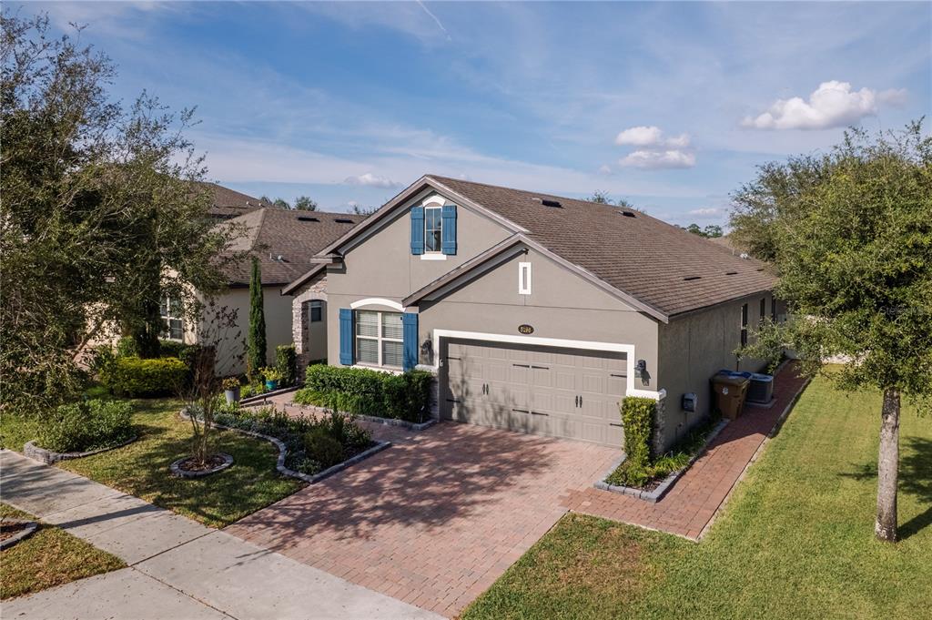 5196 Appenine Loop East St. Cloud, FL 34771 - Photo 2 of 39 a front view of a house with a yard and garage