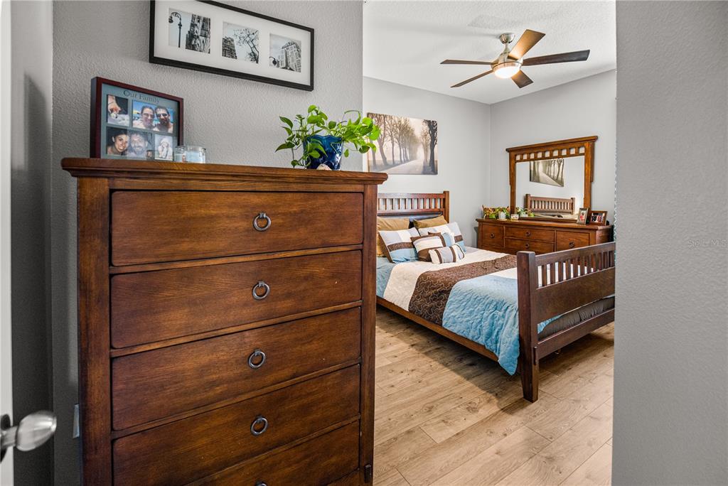 5196 Appenine Loop East St. Cloud, FL 34771 - Photo 22 of 39 a bedroom with a bed and painting on the wall