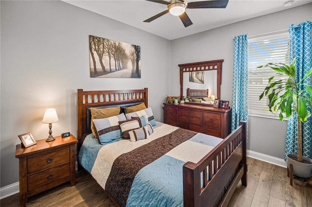 5196 Appenine Loop East St. Cloud, FL 34771 - Photo 23 of 39 a bedroom with a bed and a potted plant