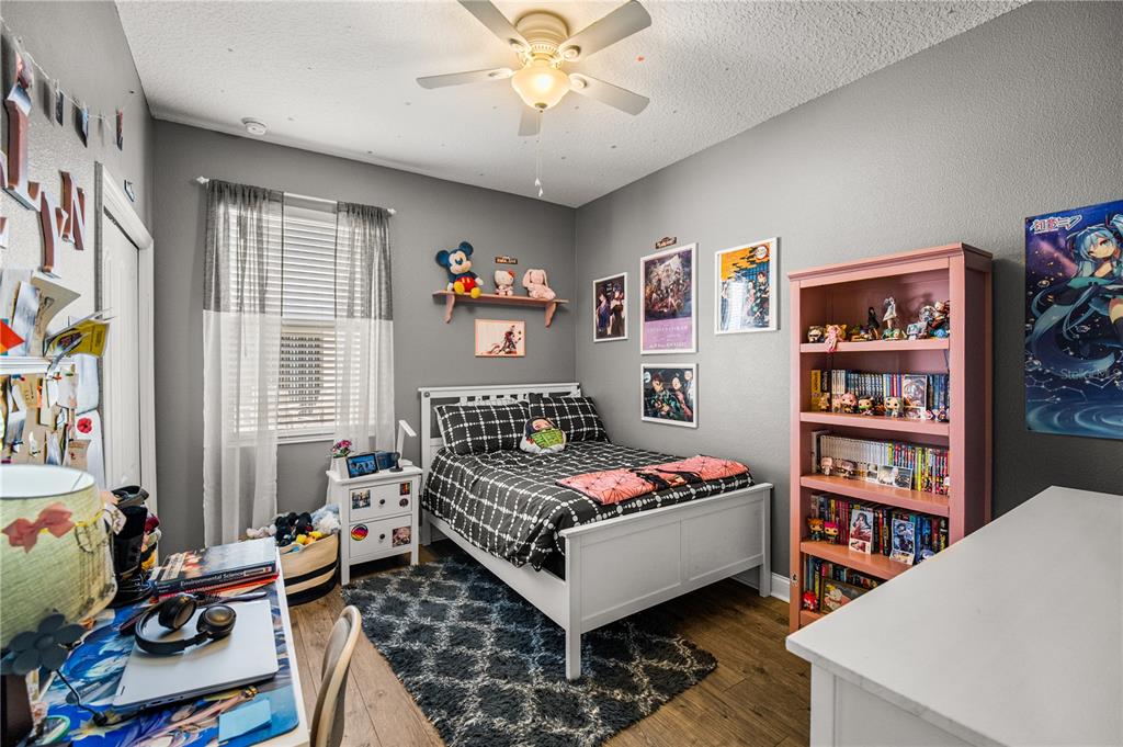 5196 Appenine Loop East St. Cloud, FL 34771 - Photo 26 of 39 a bedroom with furniture and a book shelf