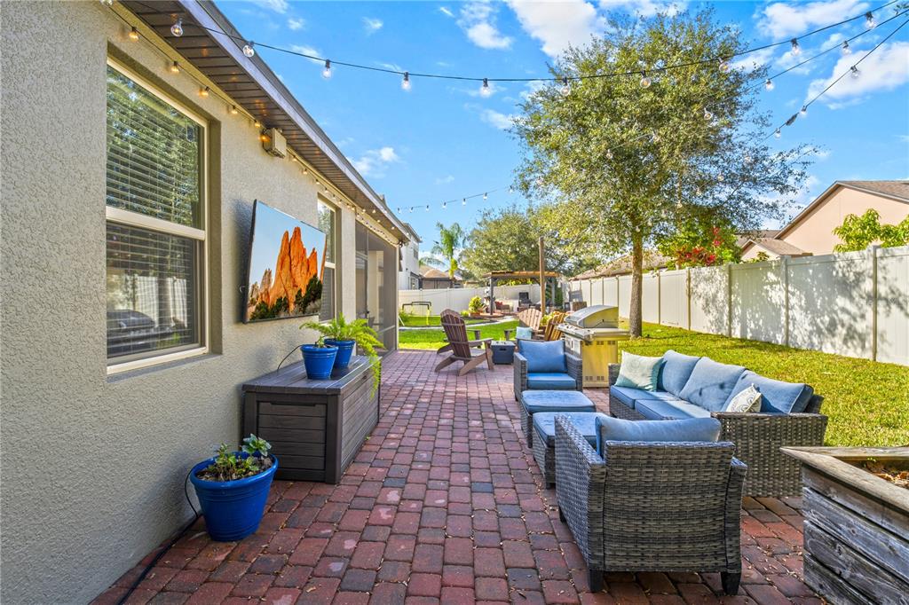5196 Appenine Loop East St. Cloud, FL 34771 - Photo 30 of 39 a view of a patio with couches chairs and a potted plant