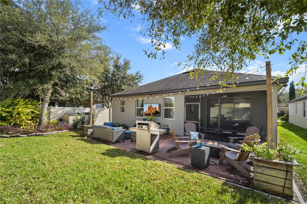 5196 Appenine Loop East St. Cloud, FL 34771 - Photo 31 of 39 a view of a house with backyard sitting area and garden