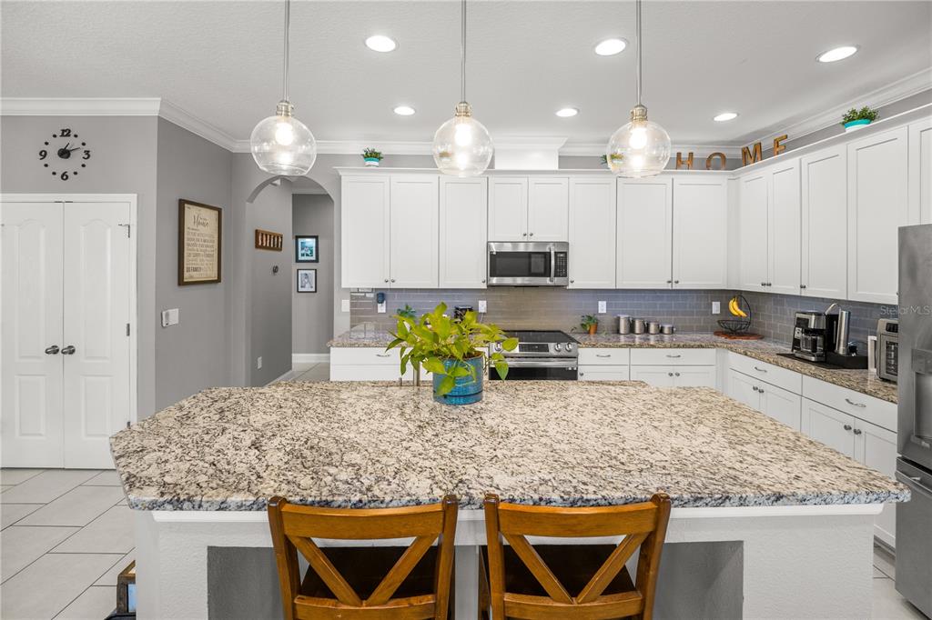 5196 Appenine Loop East St. Cloud, FL 34771 - Photo 8 of 39 a kitchen with counter top space cabinets and stainless steel appliances