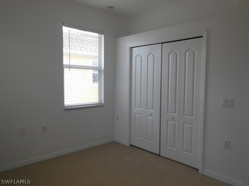 4381 Lazio Way, Unit 501 Fort Myers, FL 33901 - Photo 11 of 25 an empty room with a window