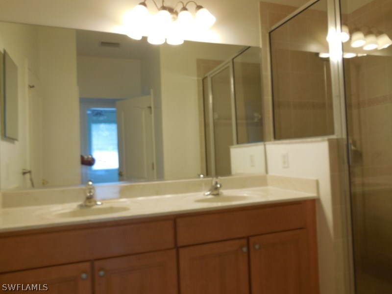 4381 Lazio Way, Unit 501 Fort Myers, FL 33901 - Photo 12 of 25 a bathroom with a sink and a mirror