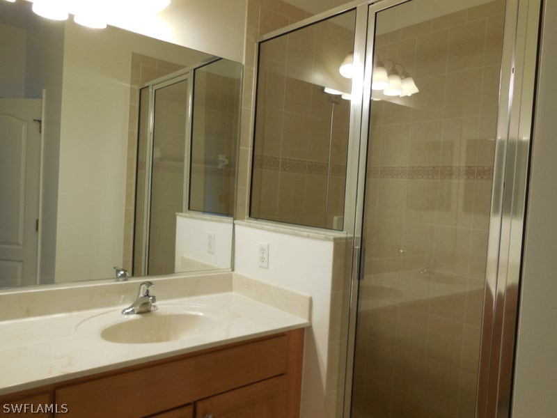 4381 Lazio Way, Unit 501 Fort Myers, FL 33901 - Photo 13 of 25 a bathroom with a sink and a mirror