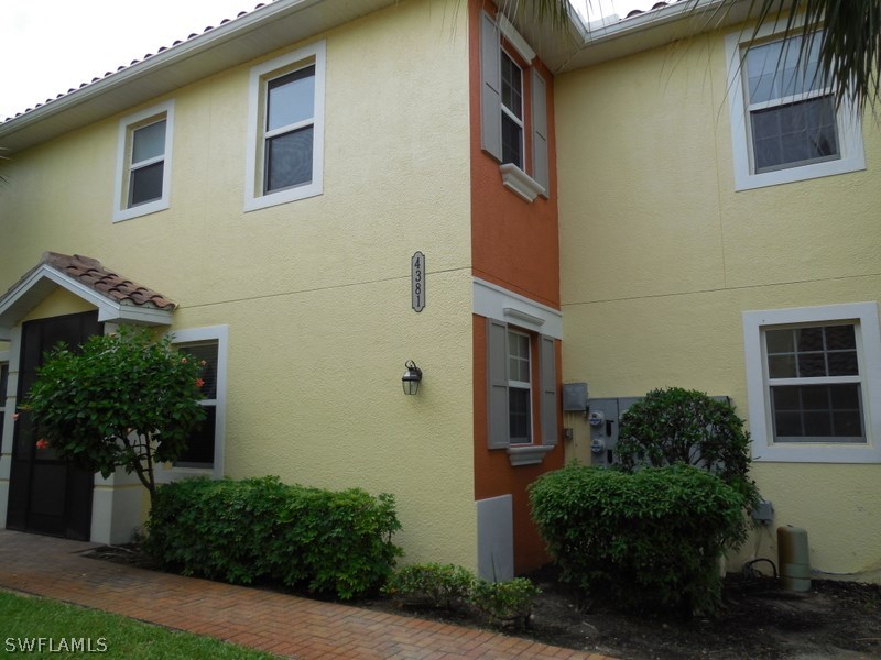 4381 Lazio Way, Unit 501 Fort Myers, FL 33901 - Photo 2 of 25 a view of a house with a yard