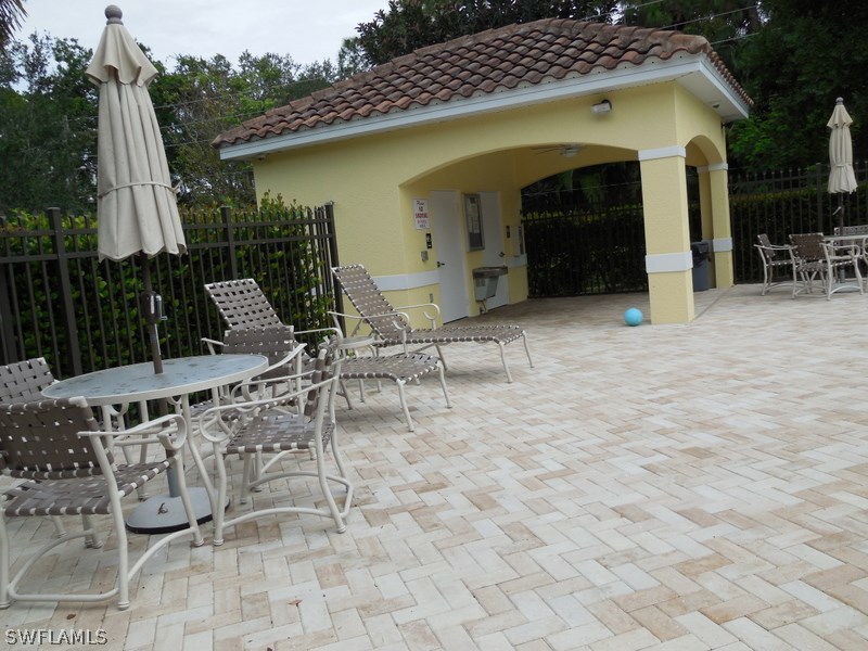 4381 Lazio Way, Unit 501 Fort Myers, FL 33901 - Photo 24 of 25 a view of a chair and tables in the patio