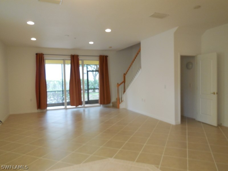 4381 Lazio Way, Unit 501 Fort Myers, FL 33901 - Photo 4 of 25 a view of an empty room with glass door