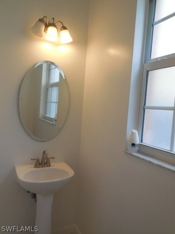 4381 Lazio Way, Unit 501 Fort Myers, FL 33901 - Photo 7 of 25 a bathroom with a sink and a mirror