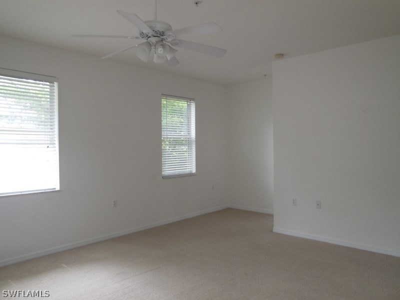 4381 Lazio Way, Unit 501 Fort Myers, FL 33901 - Photo 8 of 25 an empty room with a window and a fan