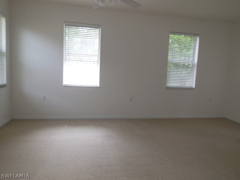 4381 Lazio Way, Unit 501 Fort Myers, FL 33901 - Photo 9 of 25 an empty room with a window