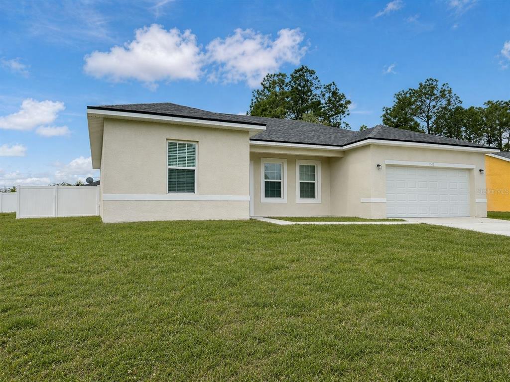 6142 Southwest 154th Place Road Ocala, FL 34473 - Photo 1 of 1 a backyard of a house with lots of green space