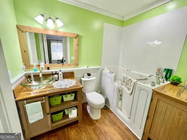 a bathroom with a sink a toilet and mirror