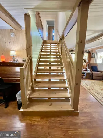 a view of entryway and hall with wooden floor