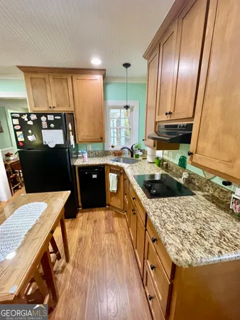 a kitchen with a sink a stove and refrigerator