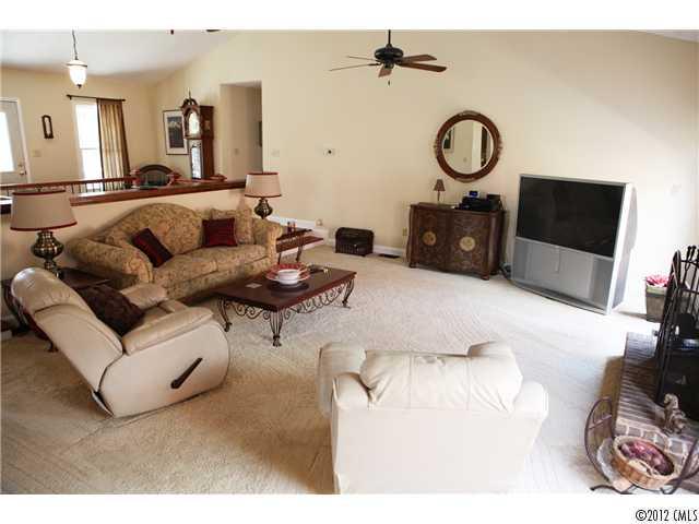 3096 Point Clear Drive Tega Cay, SC 29708 - Photo 3 of 16 a living room with furniture a flat screen tv and a wall painting