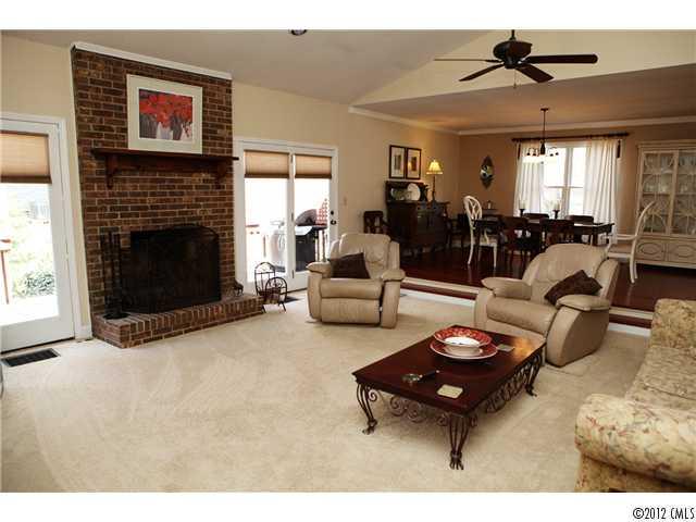 3096 Point Clear Drive Tega Cay, SC 29708 - Photo 4 of 16 a living room with furniture a fireplace and a flat screen tv