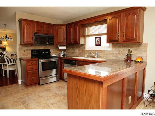 3096 Point Clear Drive Tega Cay, SC 29708 - Photo 5 of 16 a kitchen with stainless steel appliances granite countertop a sink stove and oven