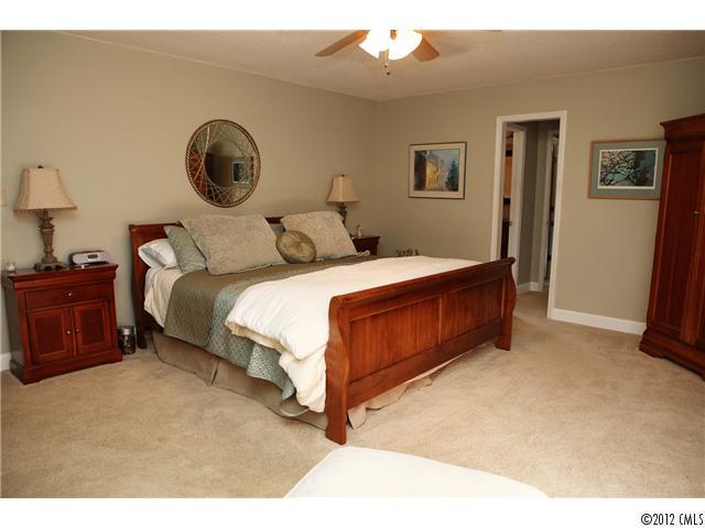 3096 Point Clear Drive Tega Cay, SC 29708 - Photo 9 of 16 a bedroom with a bed and a lamp on dresser