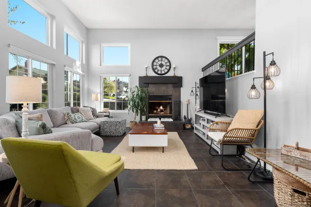 a living room with furniture a fireplace and a potted plant