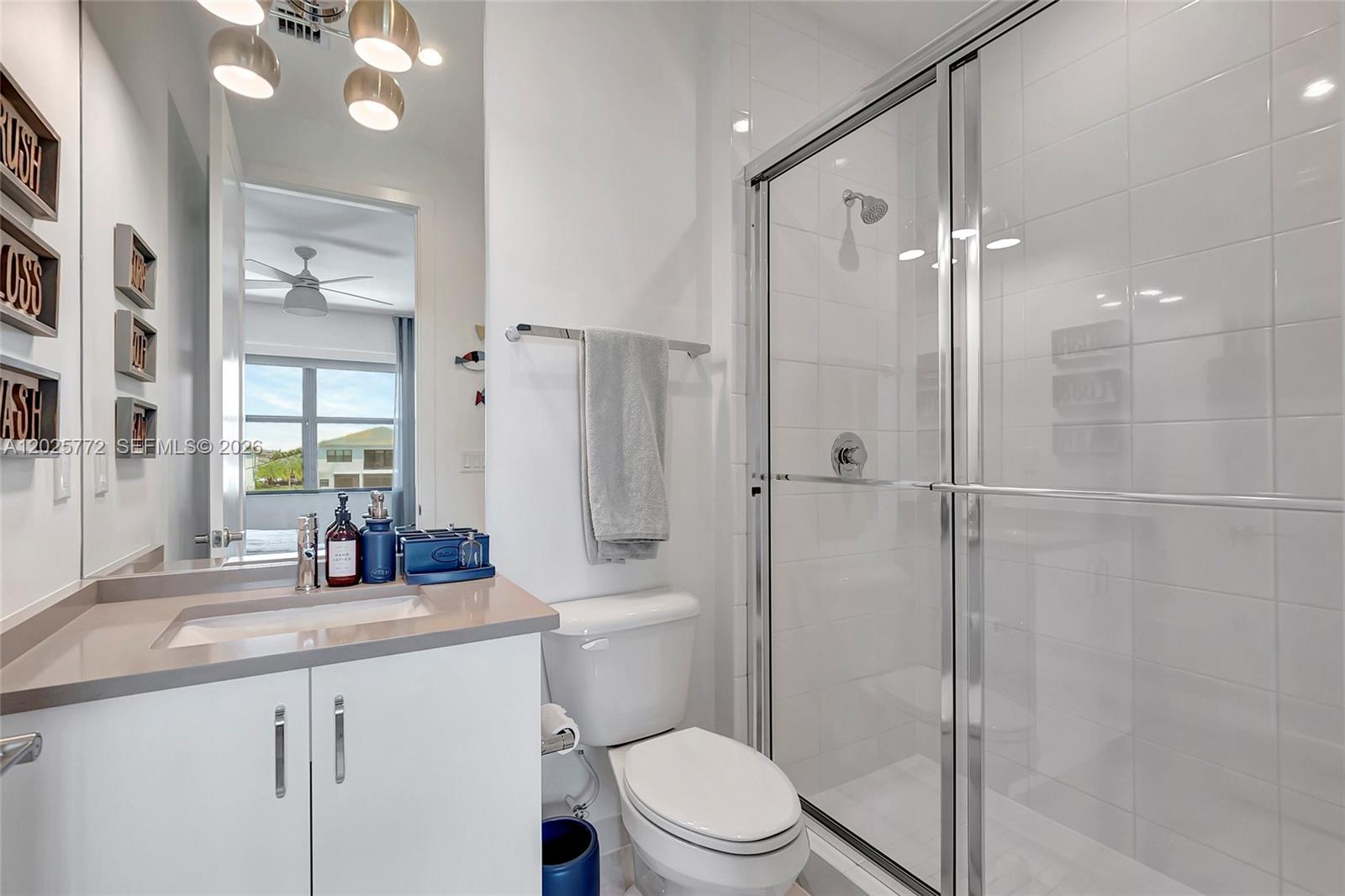 17023 Wandering Wave Avenue Boca Raton, FL 33496 - Photo 44 of 84 a bathroom with a sink a toilet and shower
