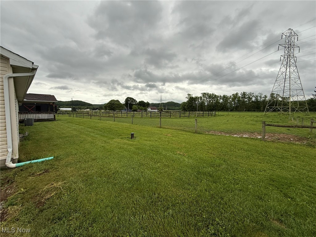 6920 Riverside Road Southeast Gnadenhutten, OH 44629 - Photo 32 of 41 View of yard featuring a rural view and central air condition unit
