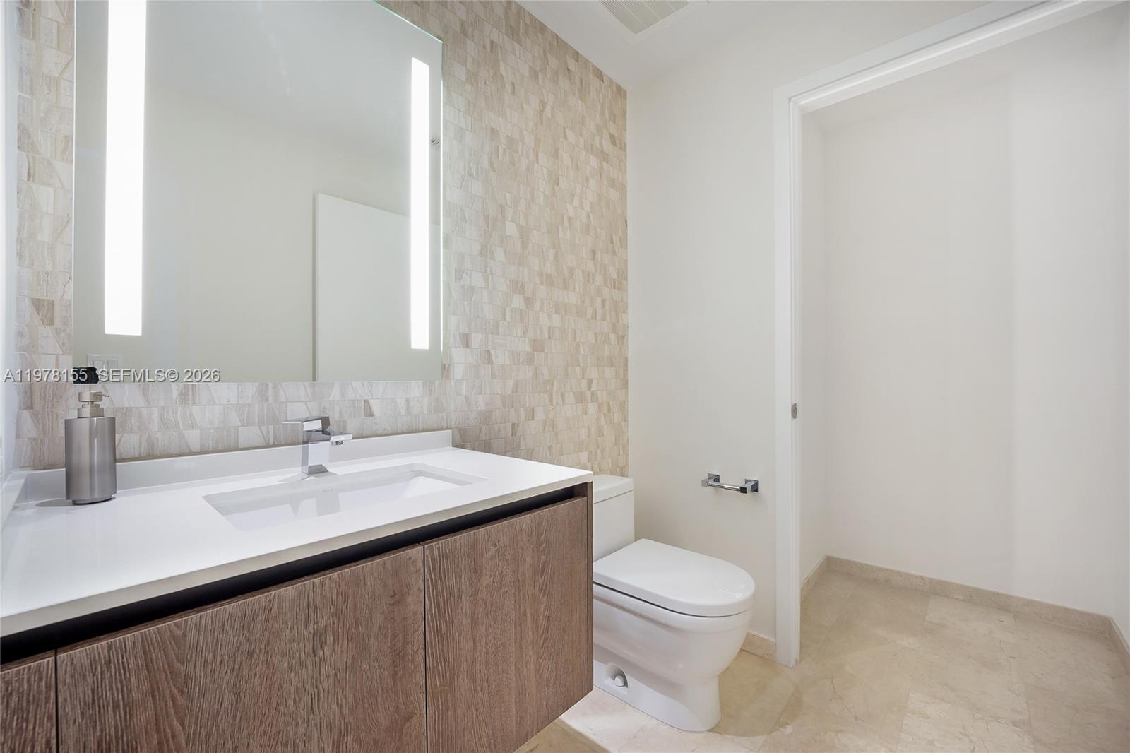 88 Southwest 7th Street, Unit 1810 Miami, FL 33130 - Photo 13 of 13 a bathroom with a sink a toilet and shower