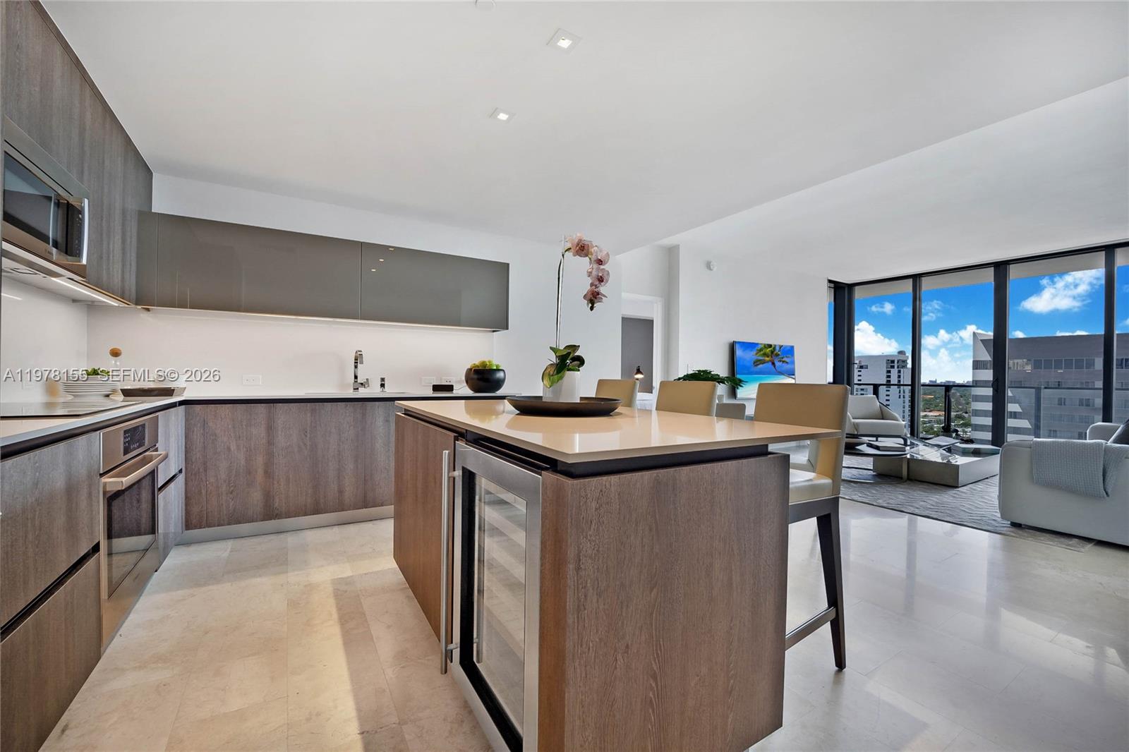 88 Southwest 7th Street, Unit 1810 Miami, FL 33130 - Photo 3 of 13 a kitchen with granite countertop a sink and stainless steel appliances