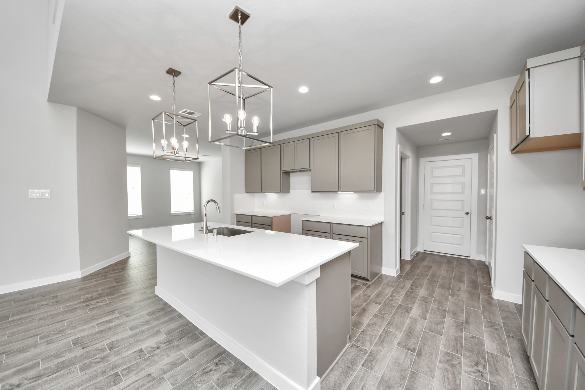 11106 Tulip Rdg Trail Houston, TX 77044 - Photo 11 of 34 The extended counter area adds both practicality and style, making meal preparation a breeze. Every detail is thoughtfully designed to enhance the kitchen's functionality and aesthetic appeal. Sample photo of completed home with similar floor plan. Actual colors and selections may vary.