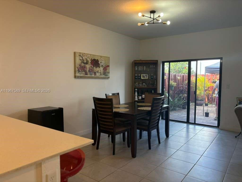 13043 Southwest 286th Street Homestead, FL 33033 - Photo 11 of 34 a view of a dining room with furniture window and outside view