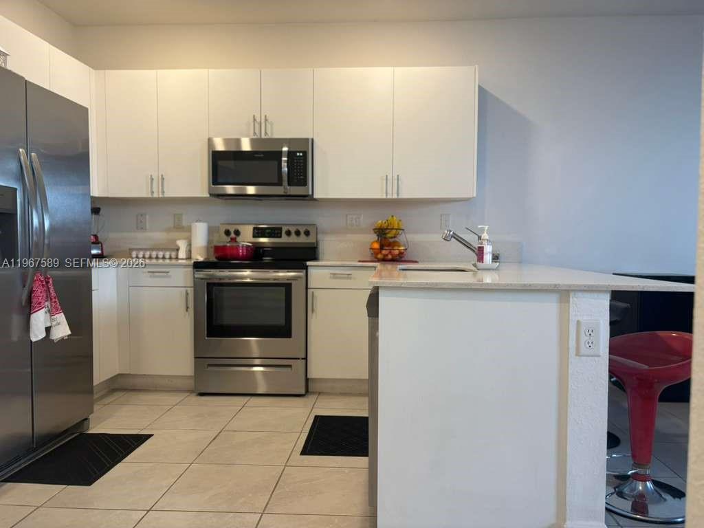 13043 Southwest 286th Street Homestead, FL 33033 - Photo 15 of 34 a kitchen with a sink and a stove top oven