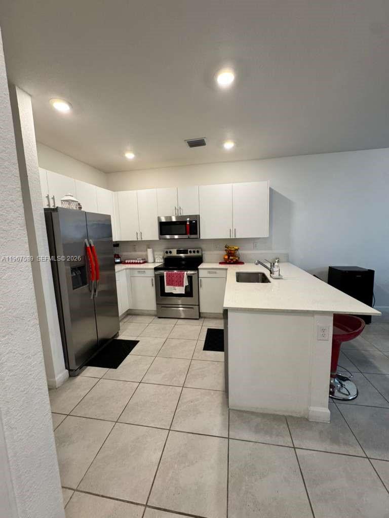13043 Southwest 286th Street Homestead, FL 33033 - Photo 17 of 34 a kitchen with a refrigerator and a sink