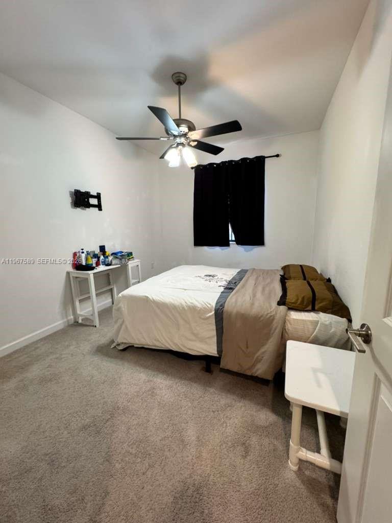 13043 Southwest 286th Street Homestead, FL 33033 - Photo 20 of 34 a bedroom with a bed and a ceiling fan