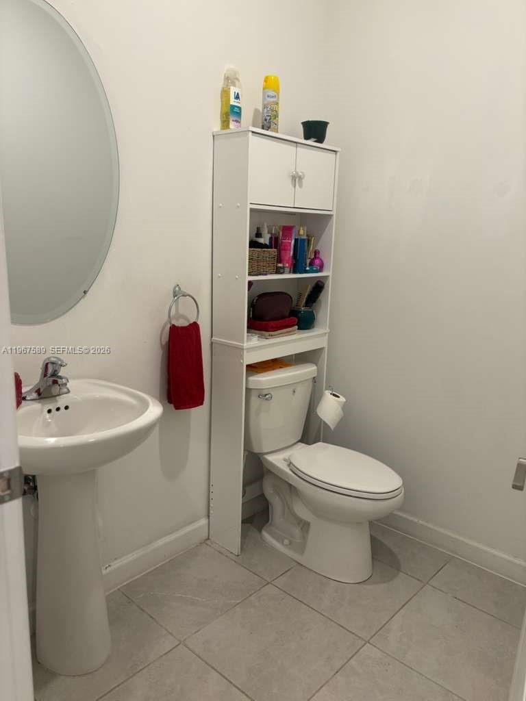 13043 Southwest 286th Street Homestead, FL 33033 - Photo 26 of 34 a bathroom with a sink toilet and a mirror