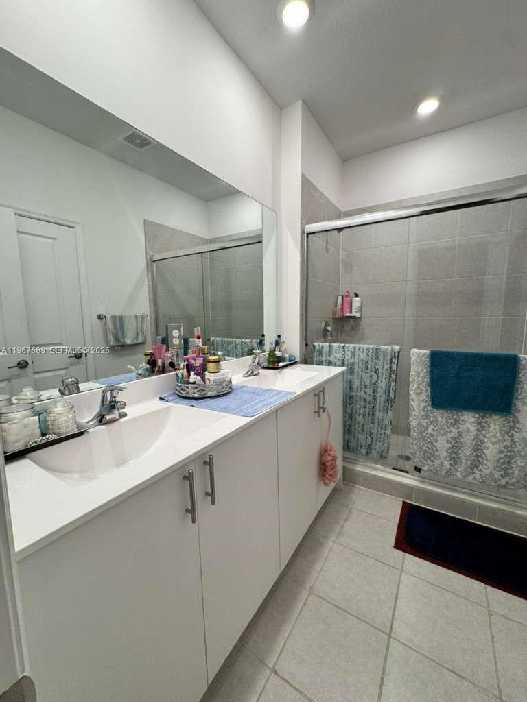 13043 Southwest 286th Street Homestead, FL 33033 - Photo 27 of 34 a bathroom with a sink double vanity and a mirror