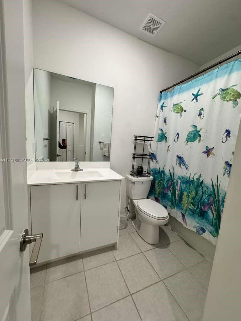 13043 Southwest 286th Street Homestead, FL 33033 - Photo 28 of 34 a bathroom with a toilet sink and mirror