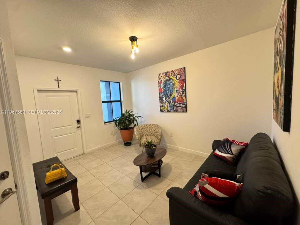 13043 Southwest 286th Street Homestead, FL 33033 - Photo 5 of 34 a living room with furniture and a window