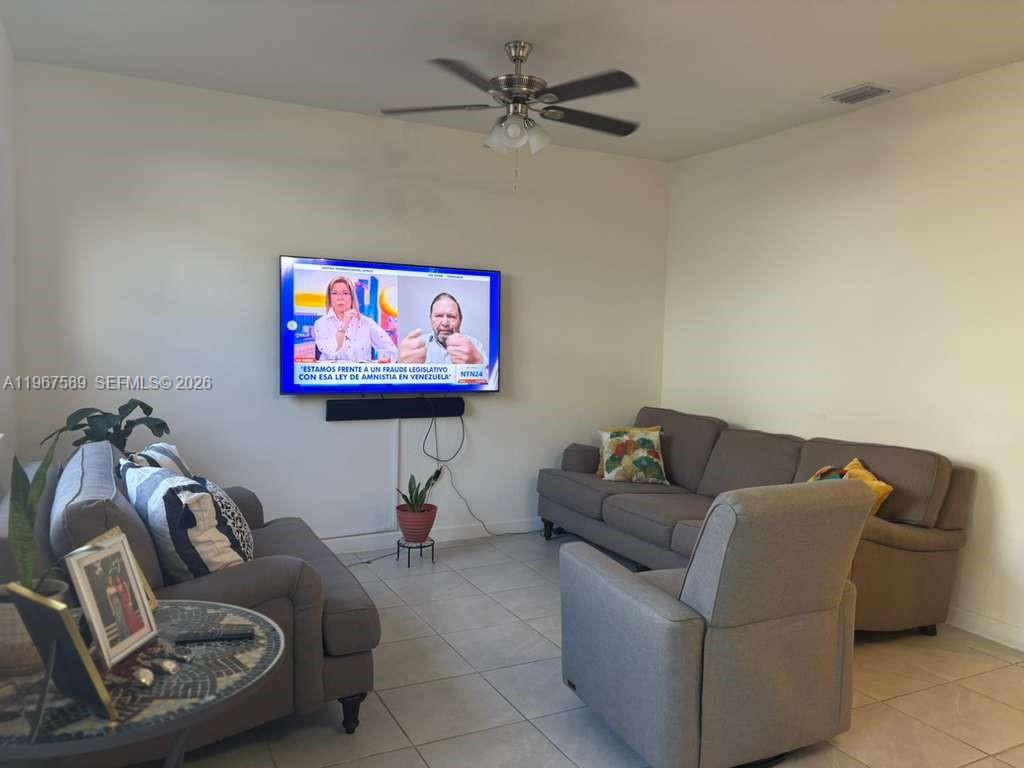 13043 Southwest 286th Street Homestead, FL 33033 - Photo 9 of 34 a living room with furniture and a flat screen tv