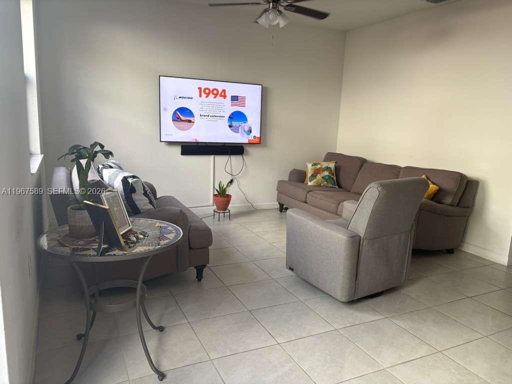 13043 Southwest 286th Street Homestead, FL 33033 - Photo 10 of 34 a living room with furniture and a flat screen tv